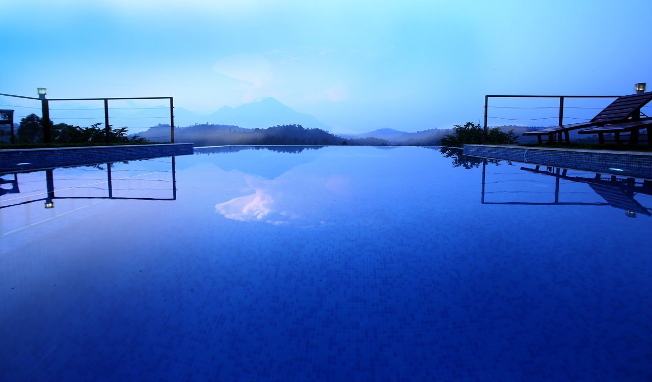 The pool reflecting the hills in blue light at dusk